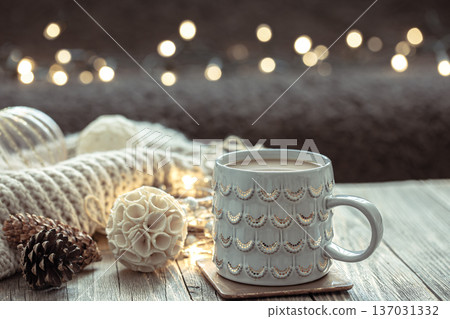 Close up of Christmas cup and winter decor details on blurred background. Close up of Christmas cup and winter decor details on blurred background. 137031332