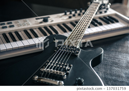 Close up, electric guitar and piano, musical creativity concept. Close up, electric guitar and piano, musical creativity concept. 137031759
