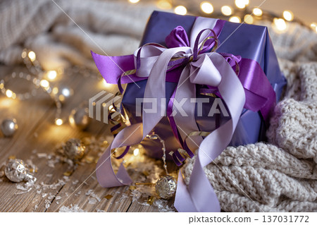 Close up of gift box on blurred background with bokeh. Close up of gift box on blurred background with bokeh. 137031772