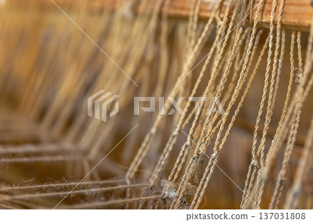 A close up image of an old weaving loom, details. A close up image of an old weaving loom, details. 137031808