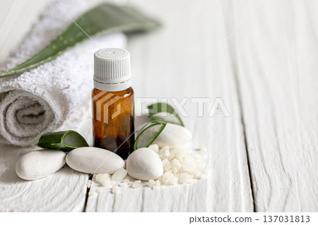 Spa composition with a jar of natural oil and aloe leaves with a towel. 137031813