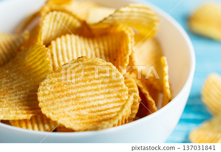Close-up, a plate of potato chips on a blurred background. Close-up, a plate of potato chips on a blurred background. 137031841