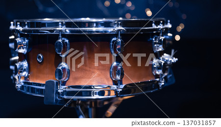 Close-up, snare drum on a blurred background with bokeh lights. Close-up, snare drum on a blurred background with bokeh lights. 137031857