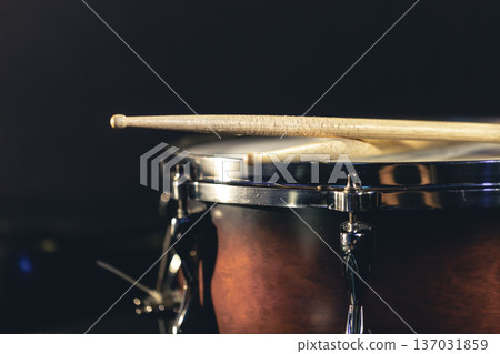 Close-up, snare drum and drumsticks on a dark background. Close-up, snare drum and drumsticks on a dark background. 137031859