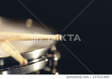 Close-up, snare drum and drumsticks on a dark background. Close-up, snare drum and drumsticks on a dark background. 137031860