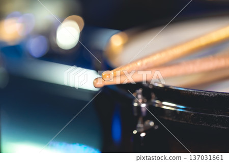 Close-up, snare drum and drumsticks on a dark background. Close-up, snare drum and drumsticks on a dark background. 137031861