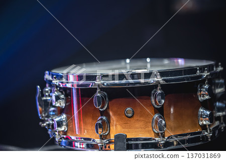 Close-up of a snare drum, percussion instrument on a dark background, copy space. Close-up of a snare drum, percussion instrument on a dark background, copy space. 137031869