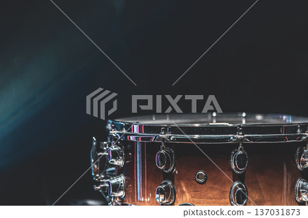 Close-up of a snare drum on a dark background with smoke, copy space. Close-up of a snare drum on a dark background with smoke, copy space. 137031873