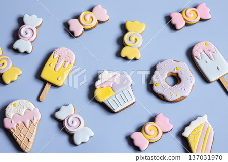 Colorful festive gingerbread cookies of different shapes covered with glaze. Colorful festive gingerbread cookies of different shapes covered with glaze. 137031970