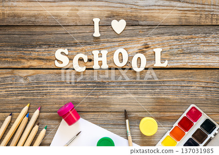 Colorful school supplies on wooden background, back to school concept. Colorful school supplies on wooden background, back to school concept. 137031985