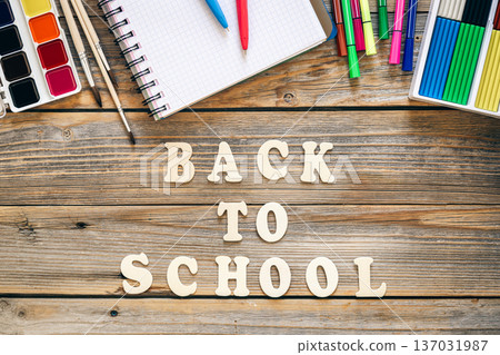Colorful school supplies on wooden background, back to school concept. Colorful school supplies on wooden background, back to school concept. 137031987