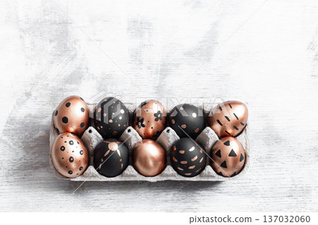 Composition with Easter eggs painted in gold and black. 137032060
