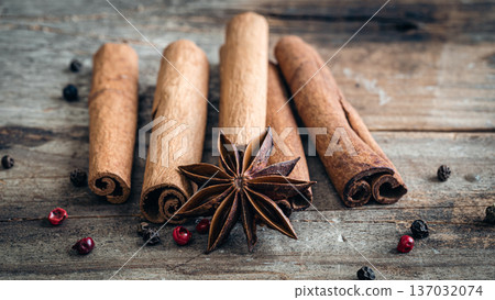 Composition with star anise and cinnamon sticks on a wooden background. 137032074