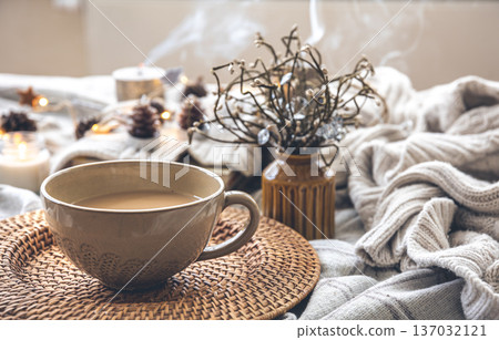 Cozy autumn composition with a big cup of coffee in bed. Cozy autumn composition with a big cup of coffee in bed. 137032121
