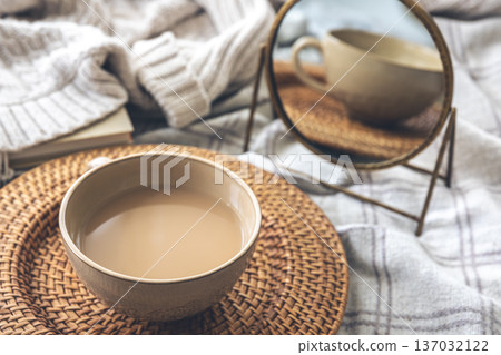 Cozy autumn composition with a big cup of coffee in bed. 137032122