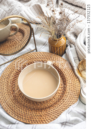 Cozy autumn composition with a cup of coffee and candles in bed. Cozy autumn composition with a cup of coffee and candles in bed. 137032125