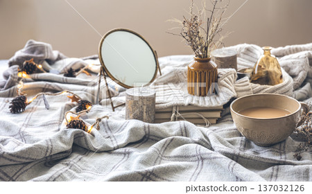 Cozy autumn composition with a cup of coffee and candles in bed. Cozy autumn composition with a cup of coffee and candles in bed. 137032126