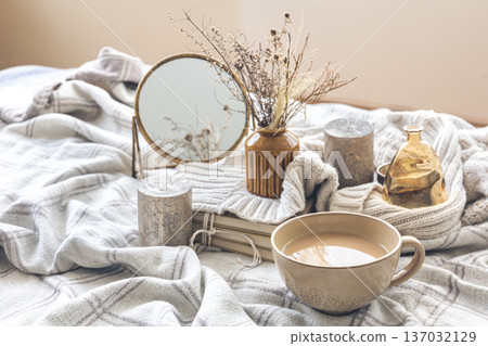 Cozy autumn composition with a cup of coffee and candles in bed. Cozy autumn composition with a cup of coffee and candles in bed. 137032129