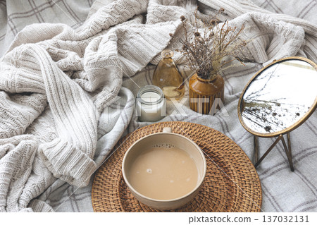 Cozy autumn composition with a cup of coffee and candles in bed. Cozy autumn composition with a cup of coffee and candles in bed. 137032131