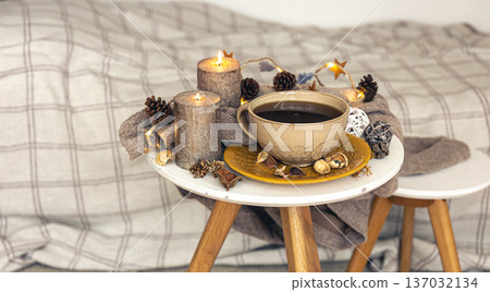 Cozy autumn composition with a cup of tea and decorative details. Cozy autumn composition with a cup of tea and decorative details. 137032134