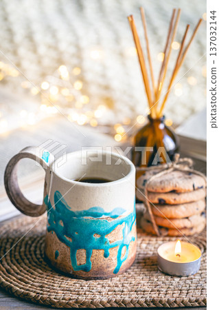 Cozy autumn composition with a handmade cup close-up. Cozy autumn composition with a handmade cup close-up. 137032144