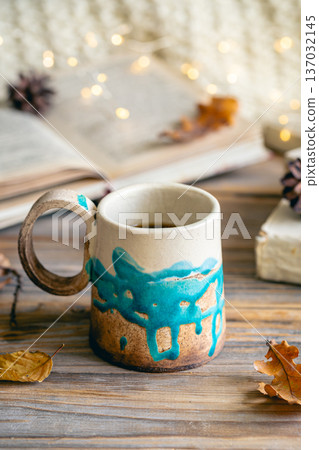 Cozy autumn composition with a handmade cup close-up. Cozy autumn composition with a handmade cup close-up. 137032145