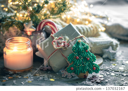 Cozy Christmas composition with a burning candle and decorative details. Cozy Christmas composition with a burning candle and decorative details. 137032167