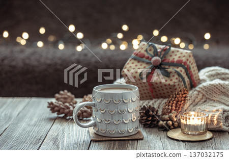 Christmas cozy background with a beautiful cup and decorative details. Christmas cozy background with a beautiful cup and decorative details. 137032175