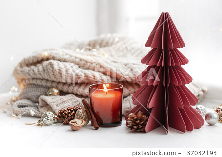 Cozy composition with burning candles, knitted element and decorative details. 137032193