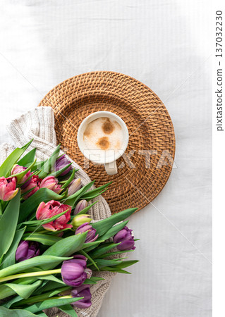 Cozy composition with flowers and coffee on a white background, top view. 137032230