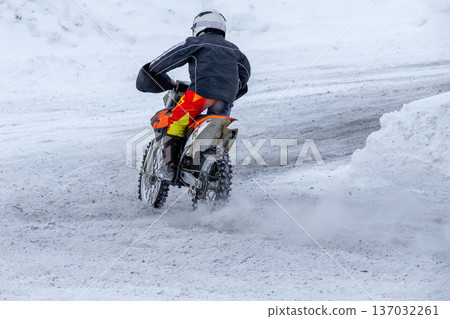 Junior motorcyclist riding dirt bike 137032261