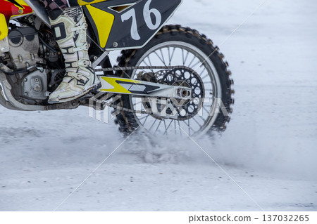 Snow dust rises from back tire 137032265