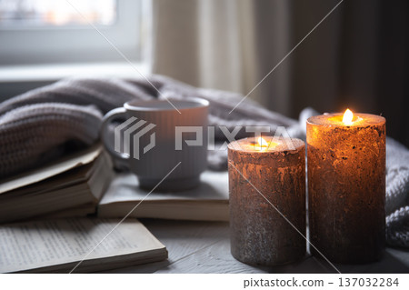 Cozy home composition with candles on a blurred background. Cozy home composition with candles on a blurred background. 137032284