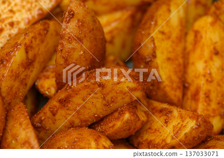 Vibrant Spiced Potato Wedges in Mixing Bowl Before Baking Vibrant Spiced Potato Wedges in Mixing Bowl Before Baking 137033071