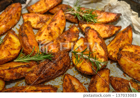 Crispy Herb Potato Wedges with Fresh Rosemary Garnish Crispy Herb Potato Wedges with Fresh Rosemary Garnish 137033083