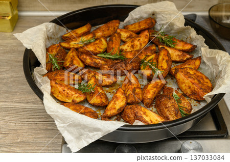 Crispy Oven-Baked Potato Wedges with Fresh Rosemary Crispy Oven-Baked Potato Wedges with Fresh Rosemary 137033084