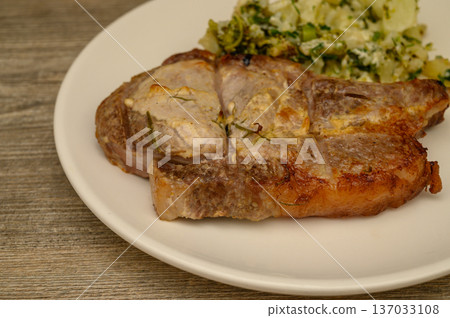 Cooked Bone-In Pork Chop with Potato Cauliflower Side 137033108