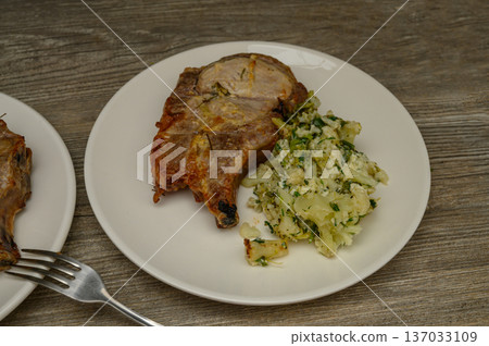 Crispy Pork Chop with Cauliflower and Fresh Herbs Plate 137033109