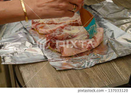 Marinating Meat Ribs with Silicone Brush on Aluminum Foil Marinating Meat Ribs with Silicone Brush on Aluminum Foil 137033120