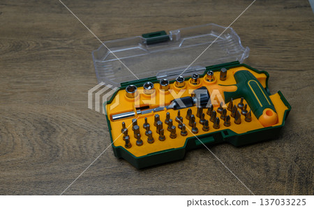 T-Handle Screwdriver Set with 45 Bits on Wooden Surface 137033225