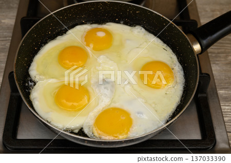 Five-Egg Omelette Frying in a Pan on a Stove Five-Egg Omelette Frying in a Pan on a Stove 137033390