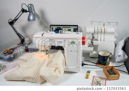 Sewing Studio with Industrial Machine, Overlocker, and Fabric Rolls Sewing Studio with Industrial Machine, Overlocker, and Fabric Rolls 137033563
