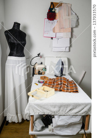 Tailor's Atelier with Mannequin Displaying a White Slip Skirt Tailor's Atelier with Mannequin Displaying a White Slip Skirt 137033570