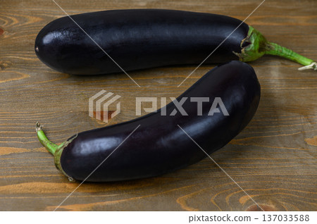 Two Eggplants on a Wooden Table Two Eggplants on a Wooden Table 137033588