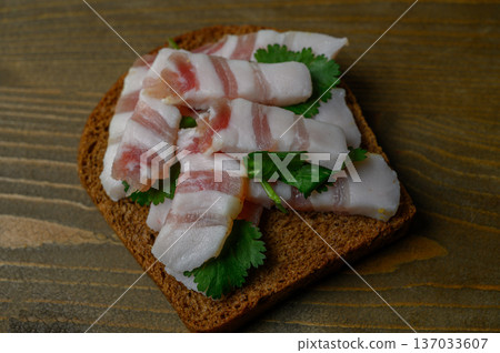 Rustic Black Bread with Salo on Aged Wood Table Rustic Black Bread with Salo on Aged Wood Table 137033607