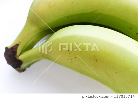 Green banana isolated on a white background. 137033714