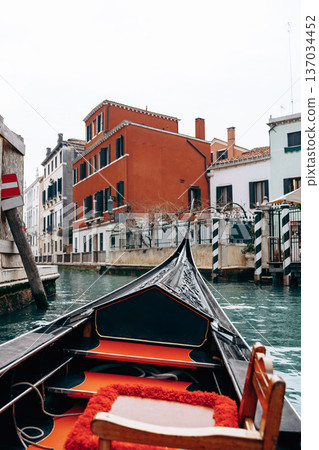 Gondola ride through canals in Venice with colorful old buildings in view Gondola ride through canals in Venice with colorful old buildings in view 137034452