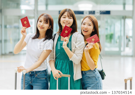 Three women leaving the airport for an overseas trip. (Photography courtesy of Kansai International Airport (KIX)) Three women leaving the airport for an overseas trip. (Photography courtesy of Kansai International Airport (KIX)) 137034514