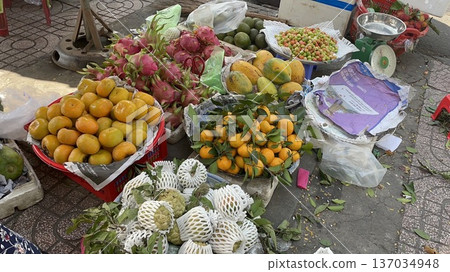 Fruits laid out on the ground at a street stall in Ho Chi Minh City, Vietnam 137034948