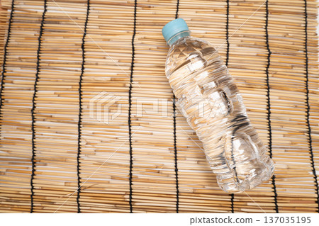 Product photography of a water bottle on a bamboo blind Product photography of a water bottle on a bamboo blind 137035195